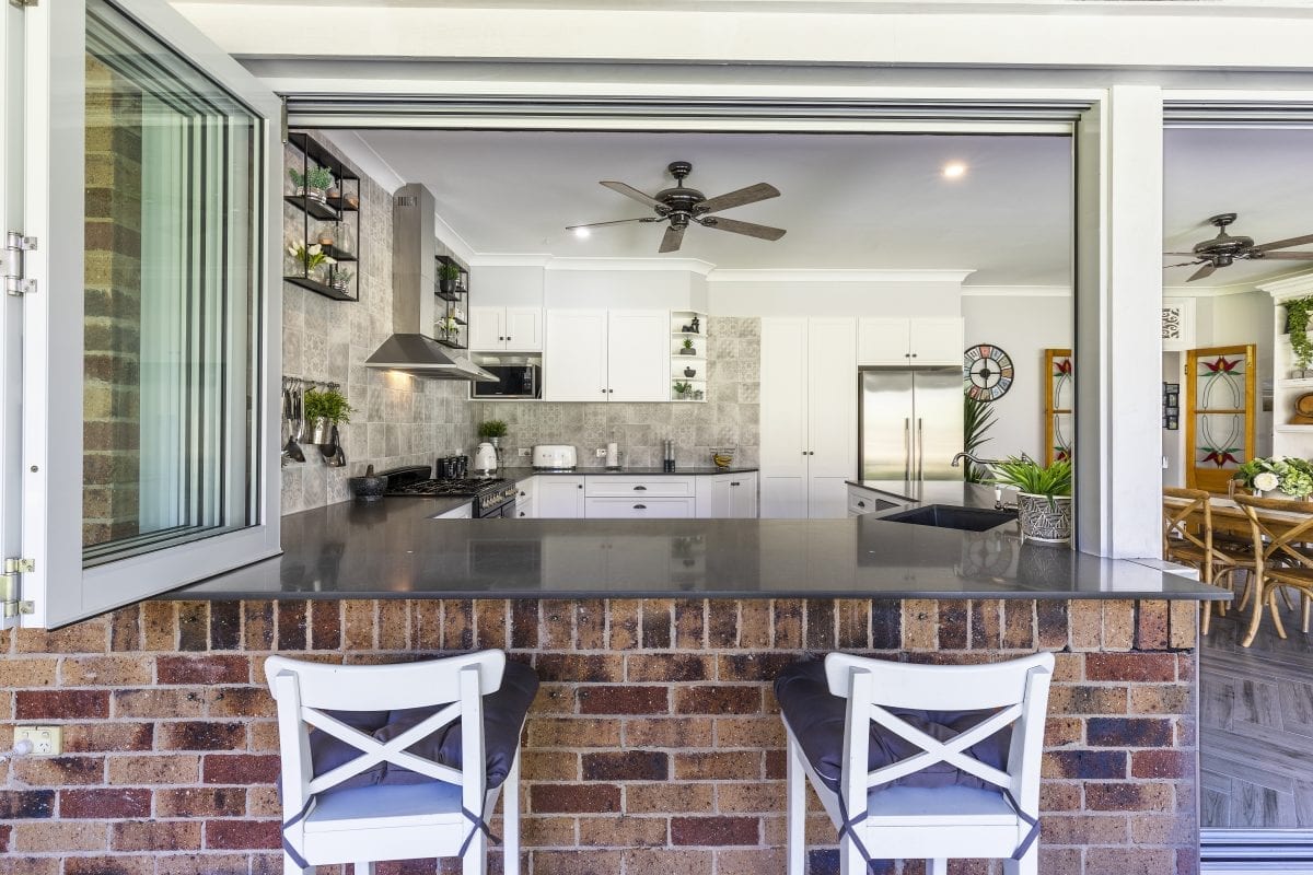 Two patio bar chairs outside kitchen servery window