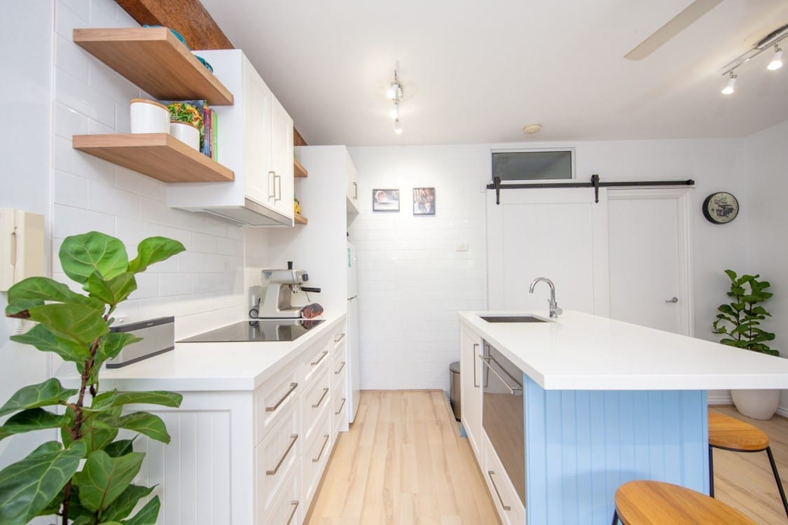 small hamptons style kitchen with blue cabinet