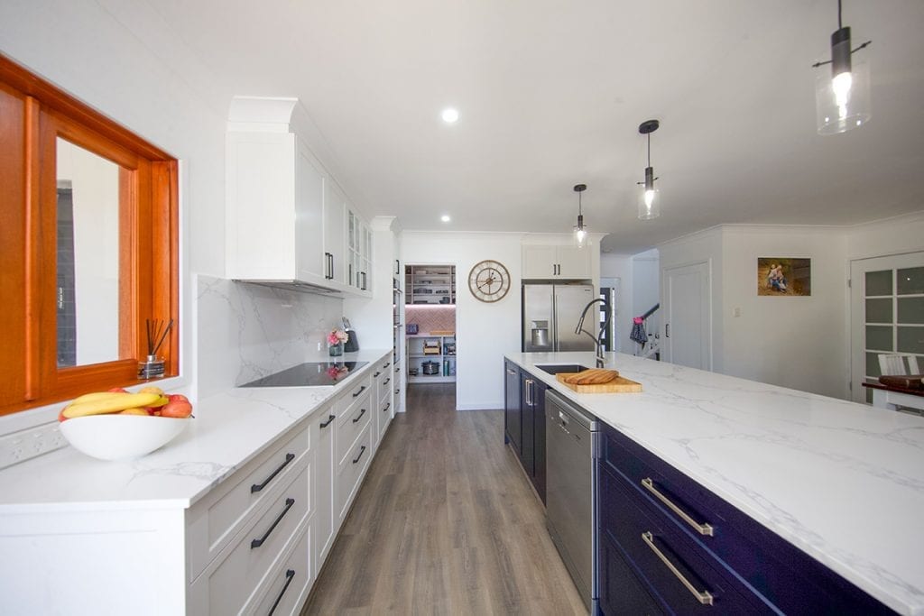 View down kitchen corridor with blue and white sliding drawers