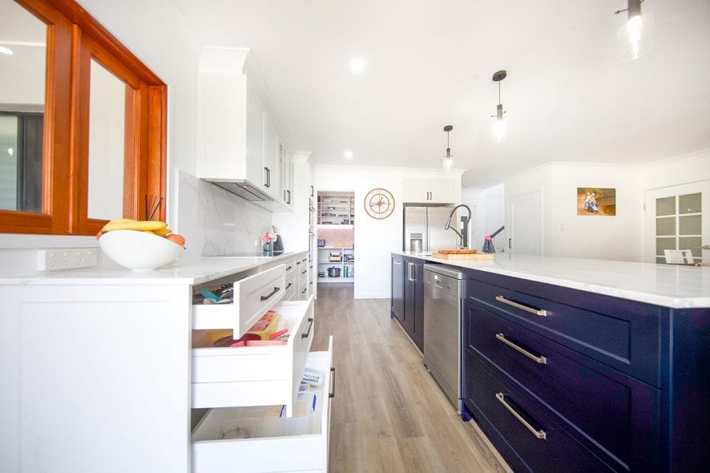 Long blue drawers and cupboards under island bench