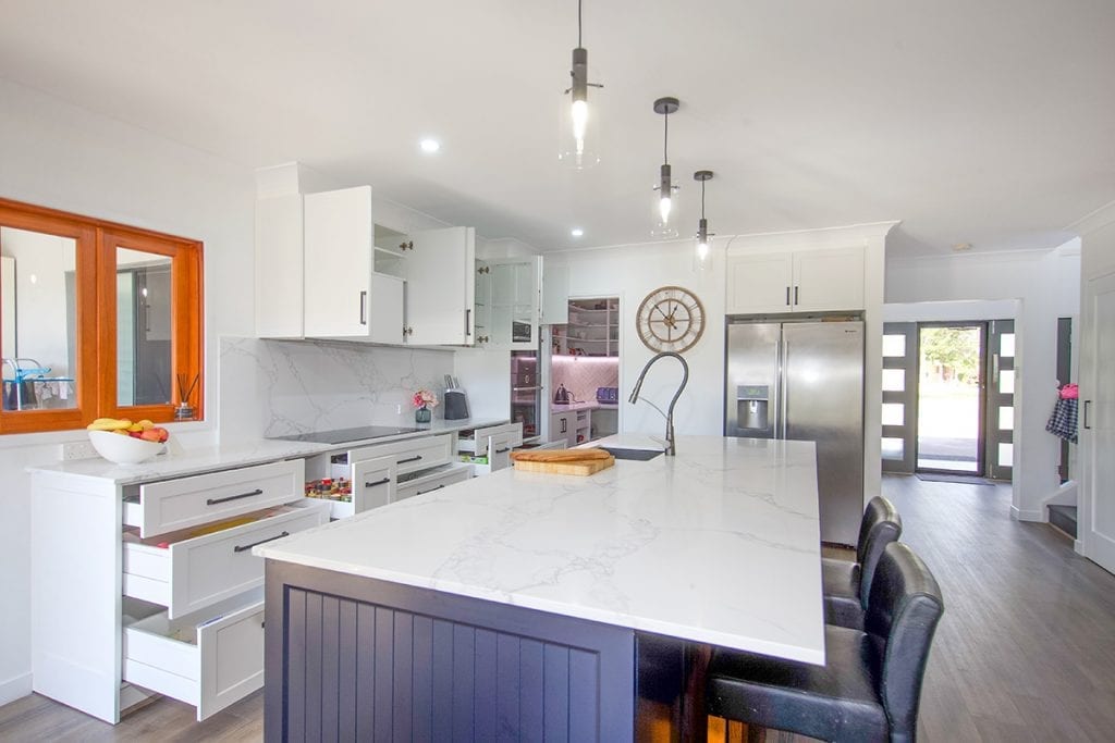 View of kitchen and down corridor to house entrance door