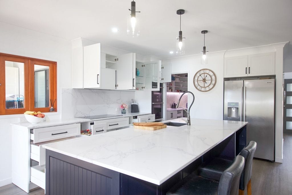 Modern white kitchen and view outside natural timber kitchen window