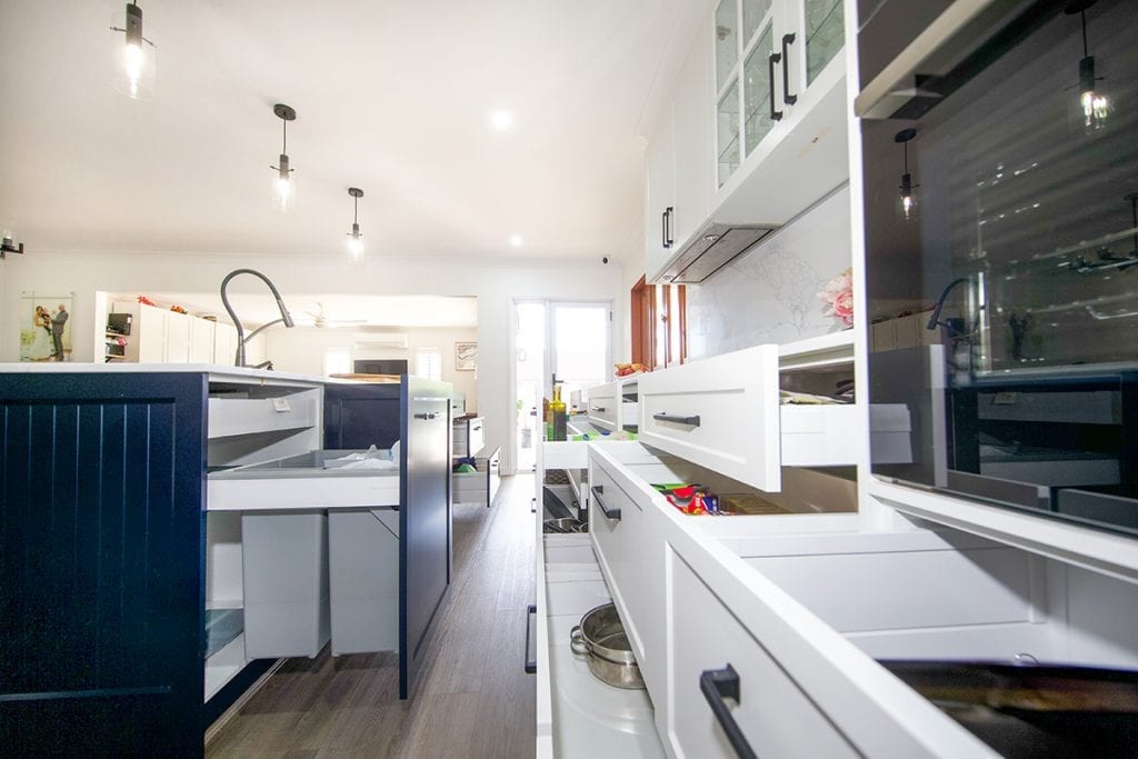 Side long view of kitchen storage drawers and bin drawer