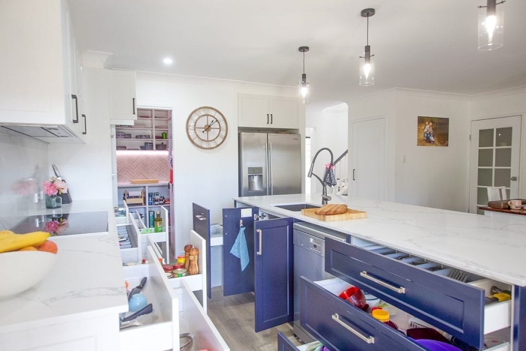 Open Blue Storage Drawers and Cupboards beside dishwasher