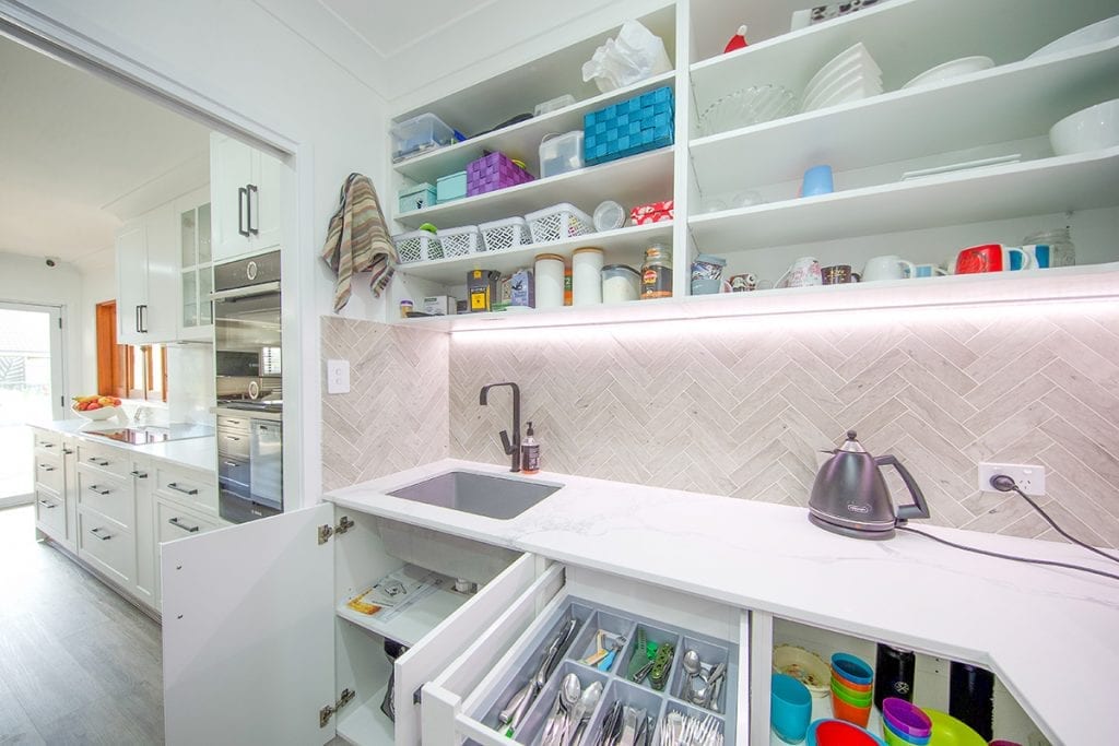 Utility bench in walk in pantry with kettle and single basin sink