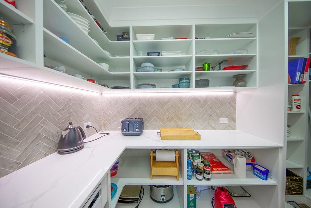 Overhead storage and under bench storage in walk in pantry