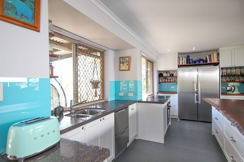 Kitchen Scene with Appliances and turquoise Splash-back