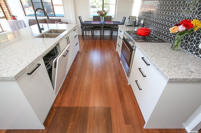 polished natural wooden floors with open dishwasher