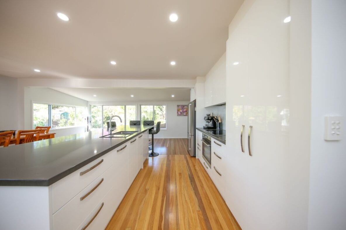 white kitchen cabinets with hardwood flooring