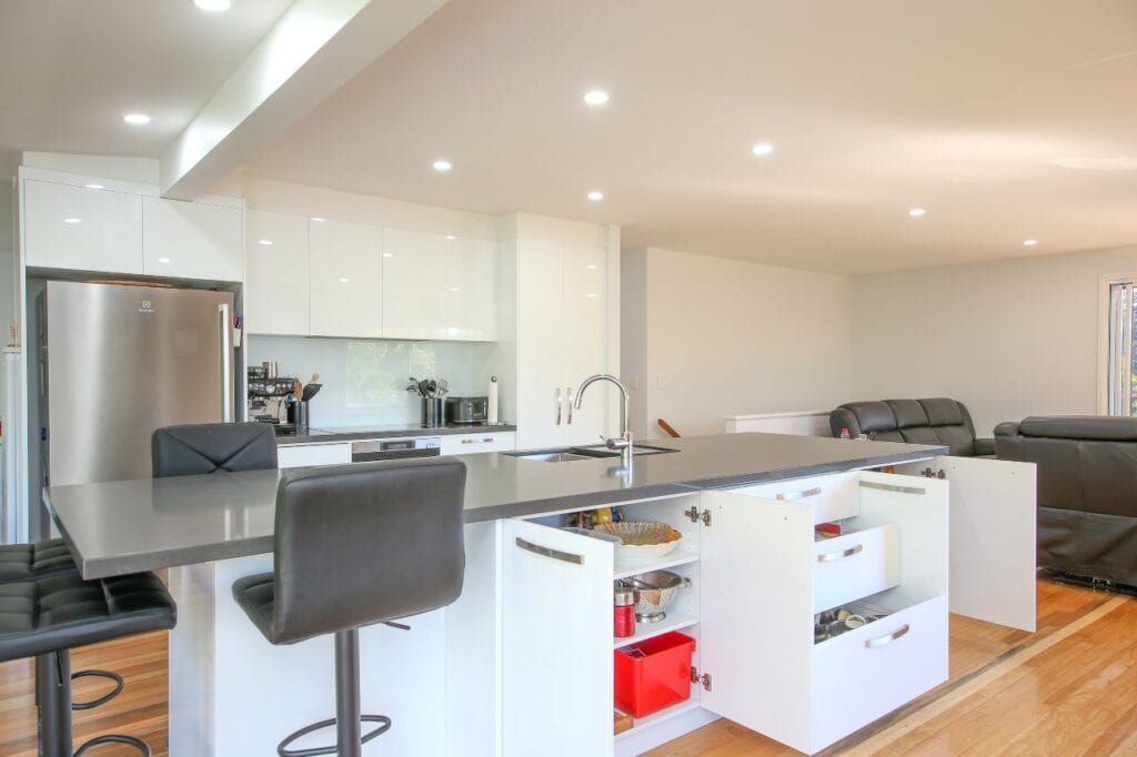 Black bar stools under grey island bench top