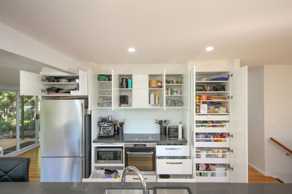Abundant storage space with pantry, above head storage and over fridge cupboards