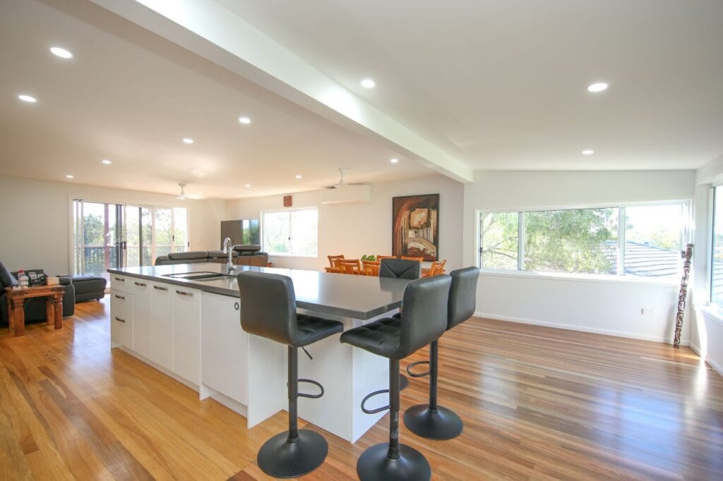 Wide view of polished timber floors and living room in background