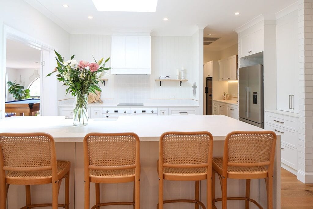 Hamptons Kitchen Setting With Bar Stools and Floral Vase