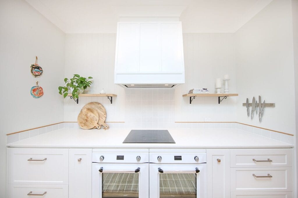 Double white kitchen stove with rangehood