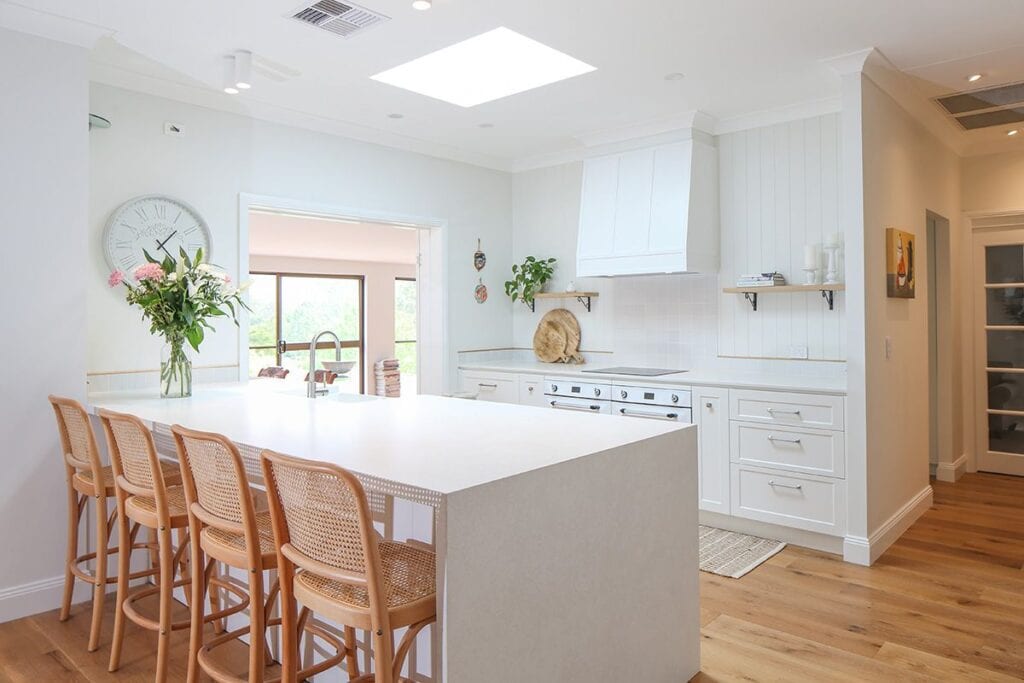 Hampton Style Kitchen Setting with Outdoor Views and Wooden Floors