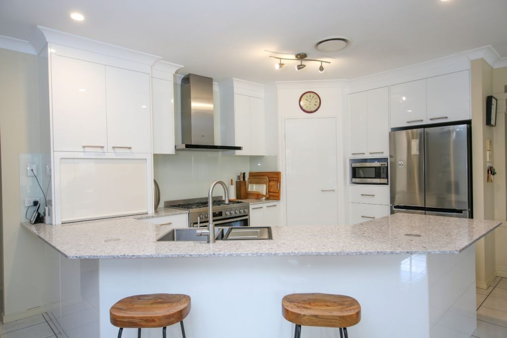 Kitchen Setting with Barstools, Sink Mixer and Stove