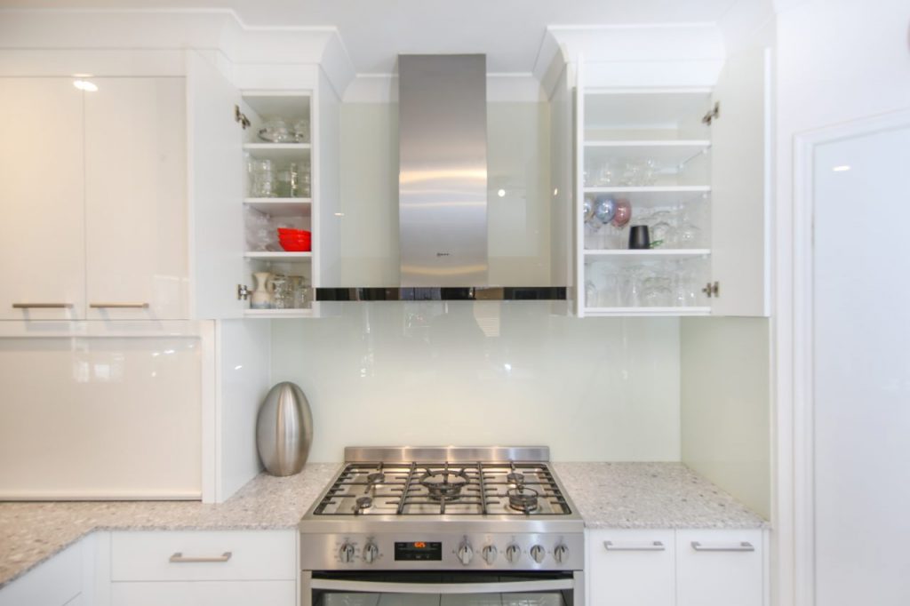 Kitchen Stove and Rangehood with Open Overhead Cabinets