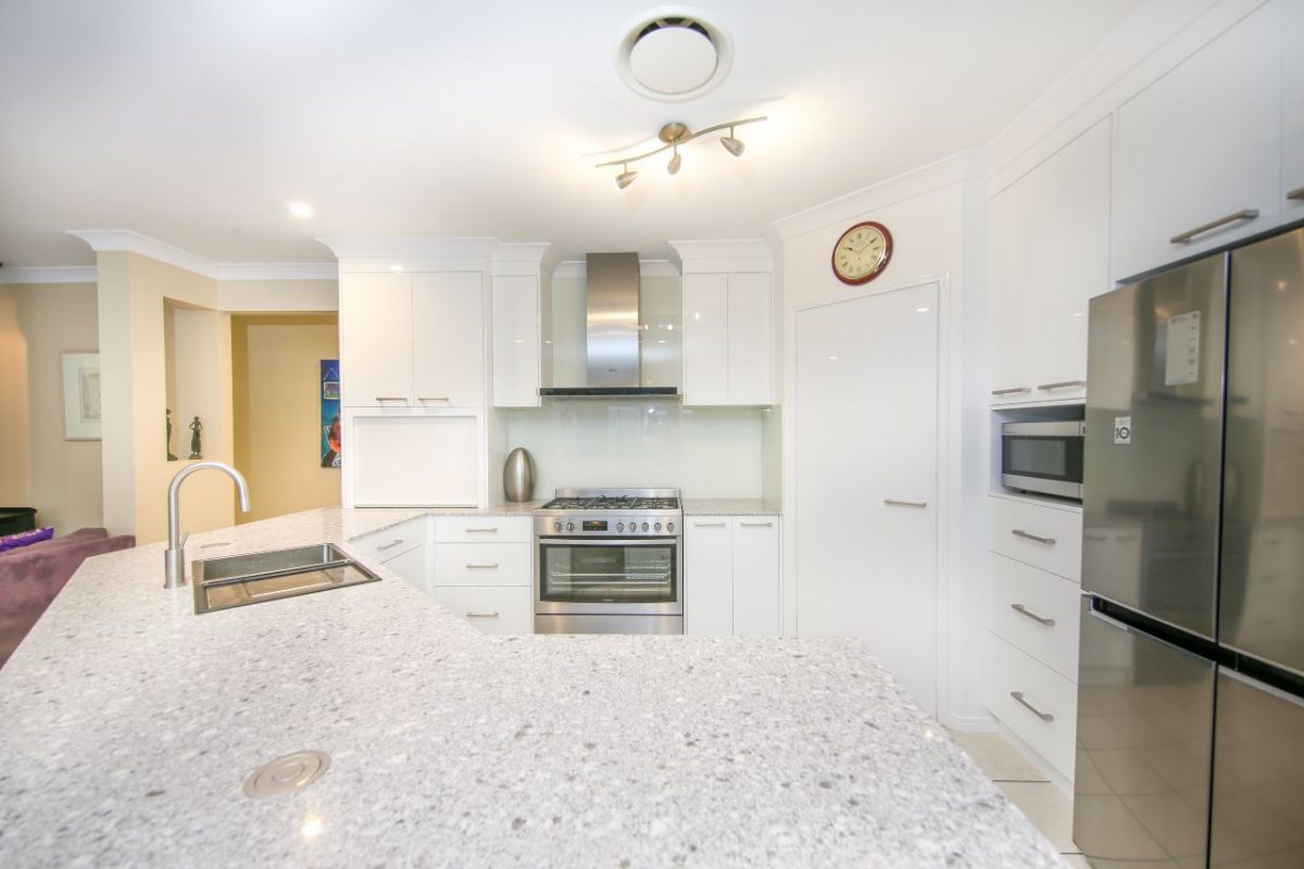 A clean white tiled kitchen renovation