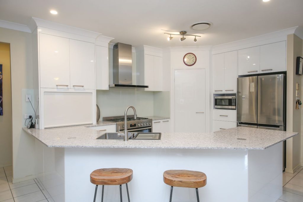 Kitchen Setting With Barstools and Marble Bench top