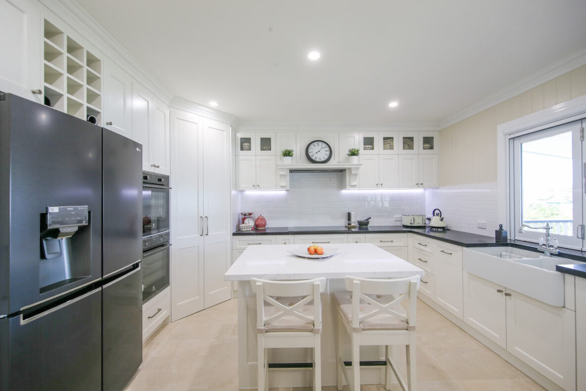 renovated Hampton shaker style kitchen with black appliances
