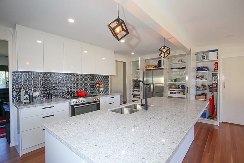 Small white kitchen with wood floors