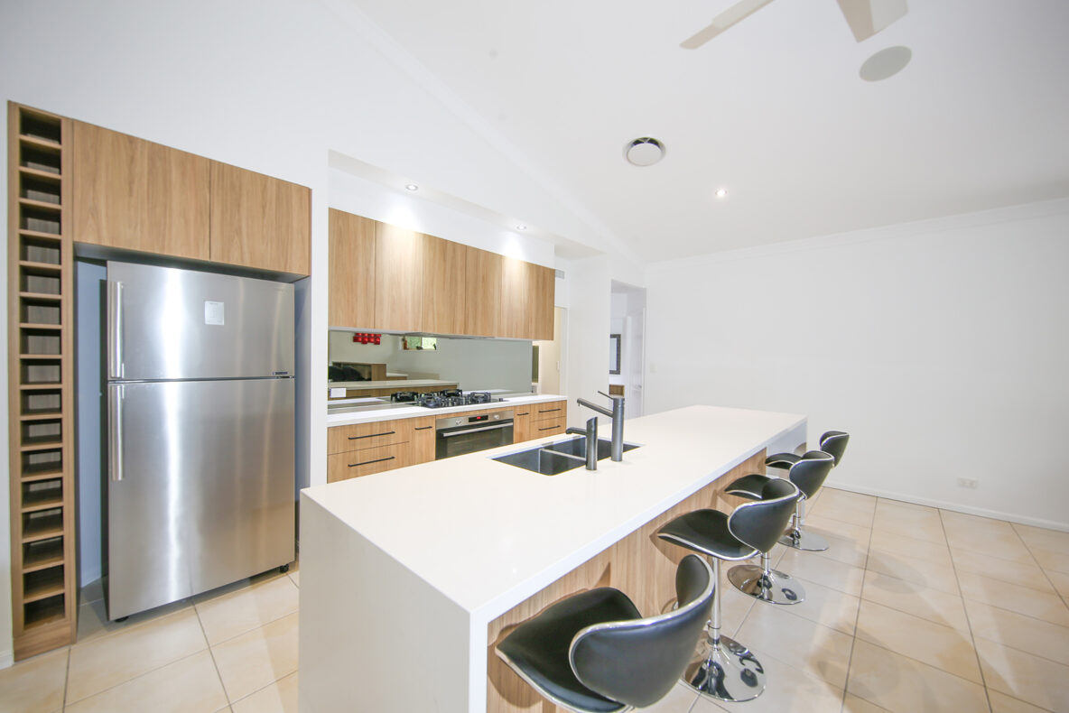 modern kitchen renovation with waterfall benchtop and wooden panelling