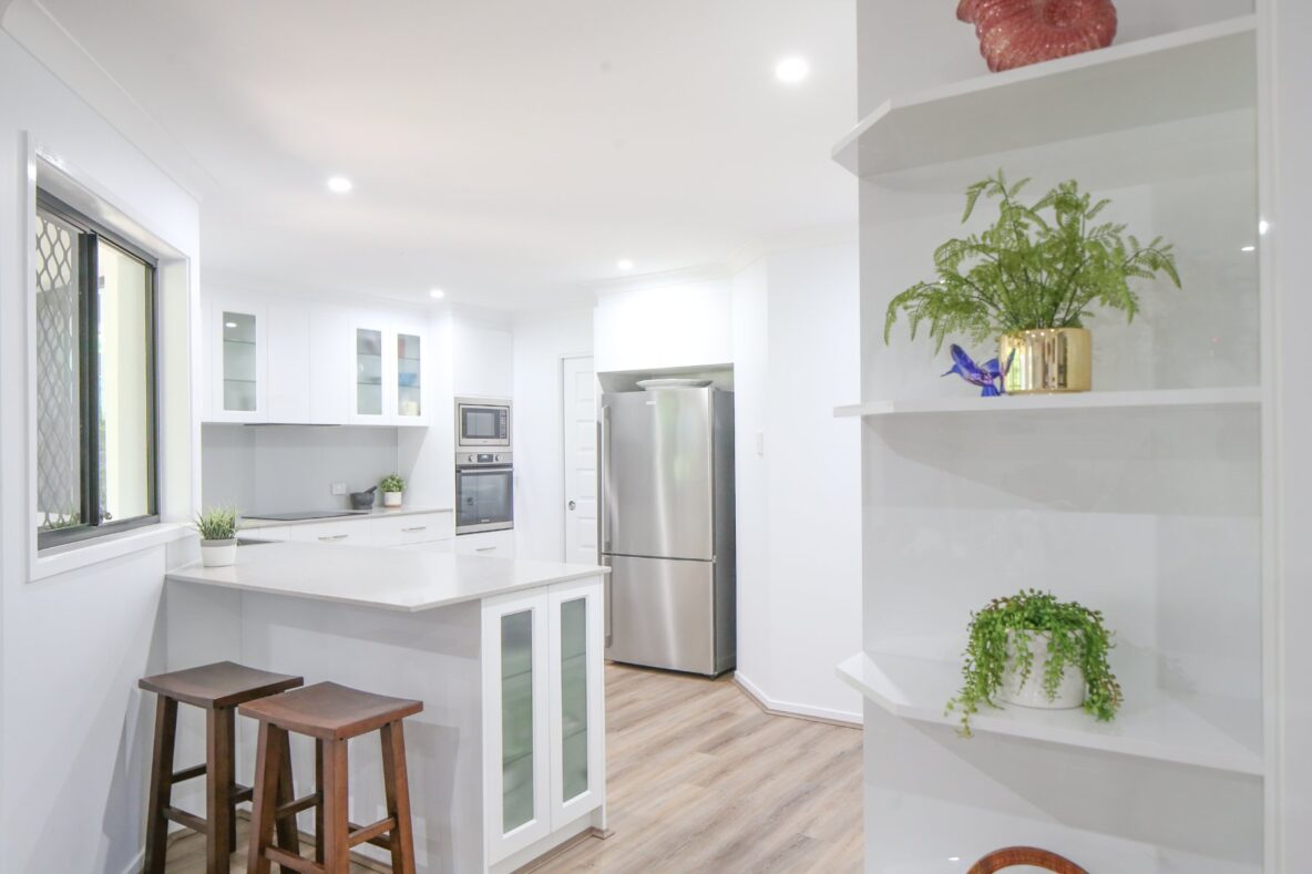 modern white kitchen renovation with wooden floors