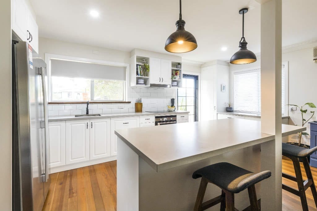 Wooden floors and white cabinets in kitchen