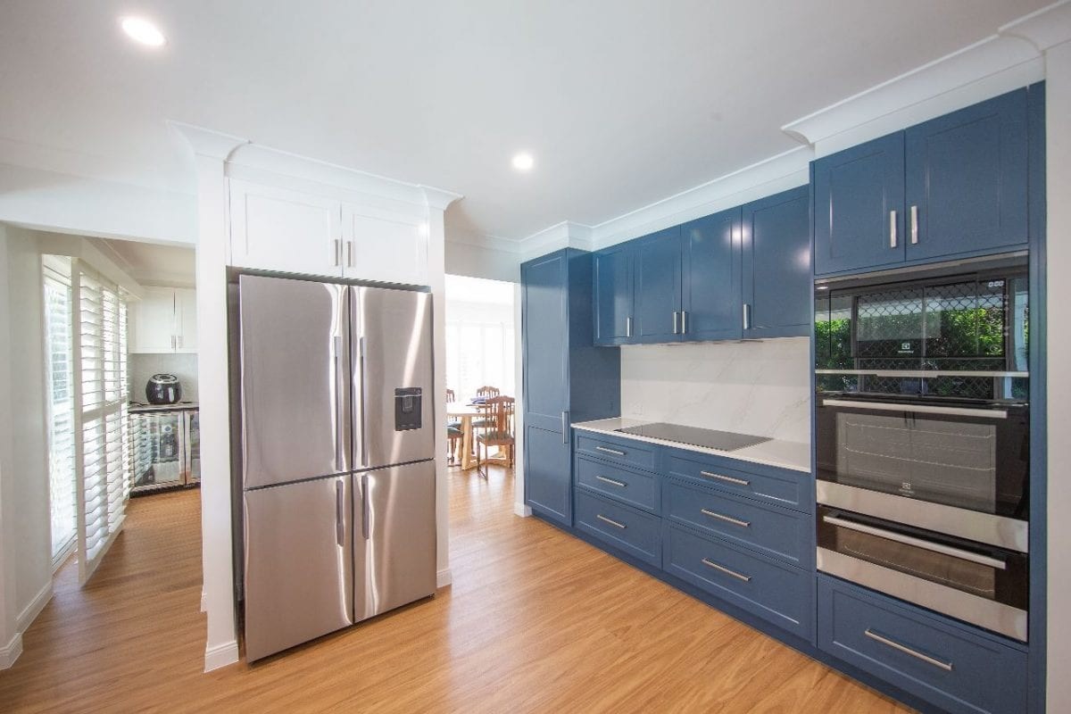 Country blue floor to ceiling wood cabinets